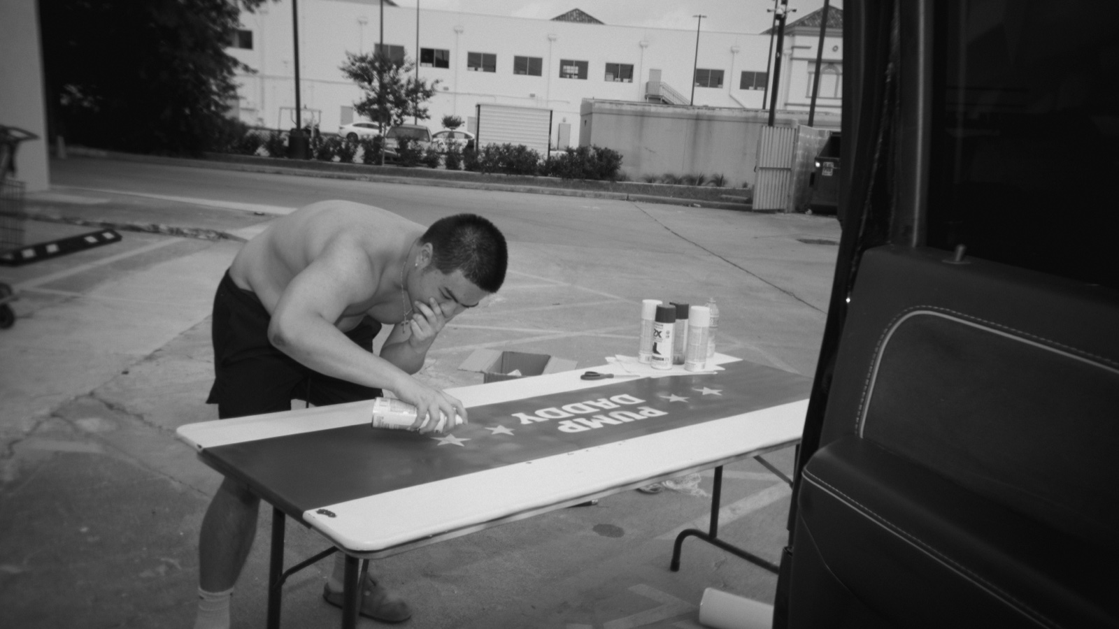 Peeling a stencil off a van to reveal the freshly-sprayed Pump Daddy design.